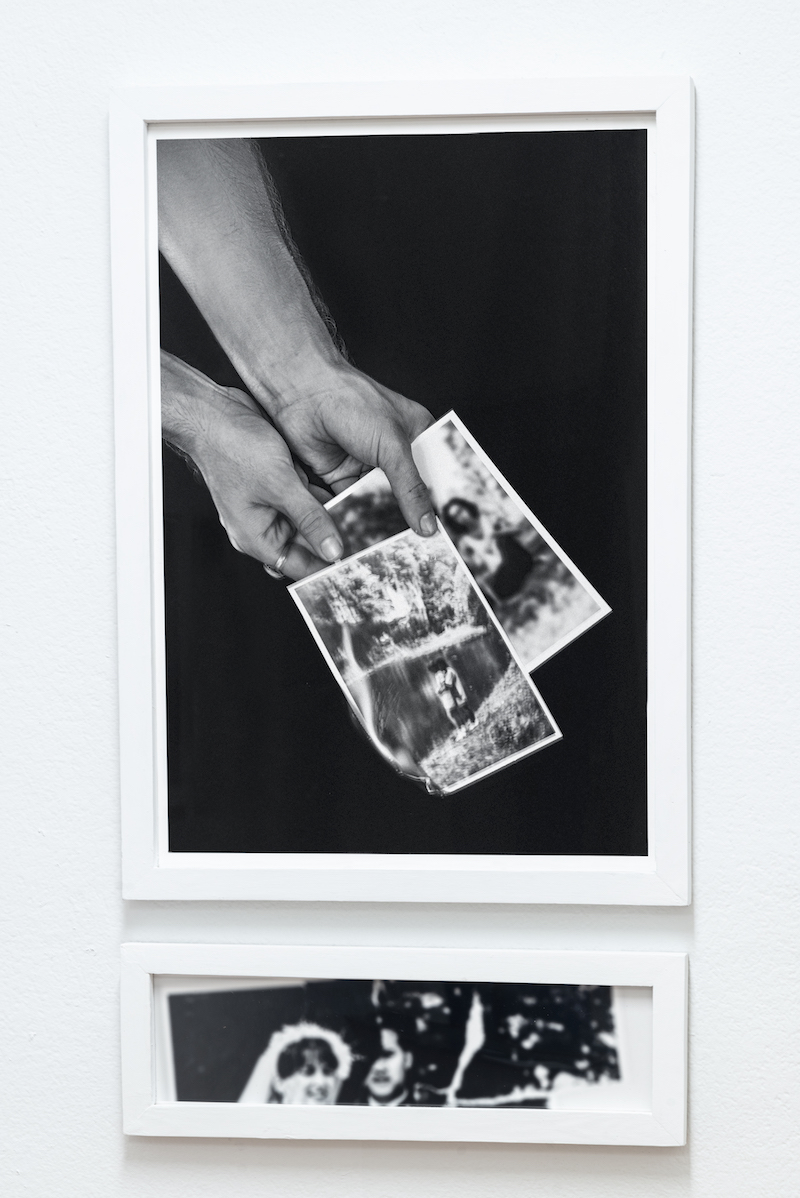 black and white photograph hands holding burning images