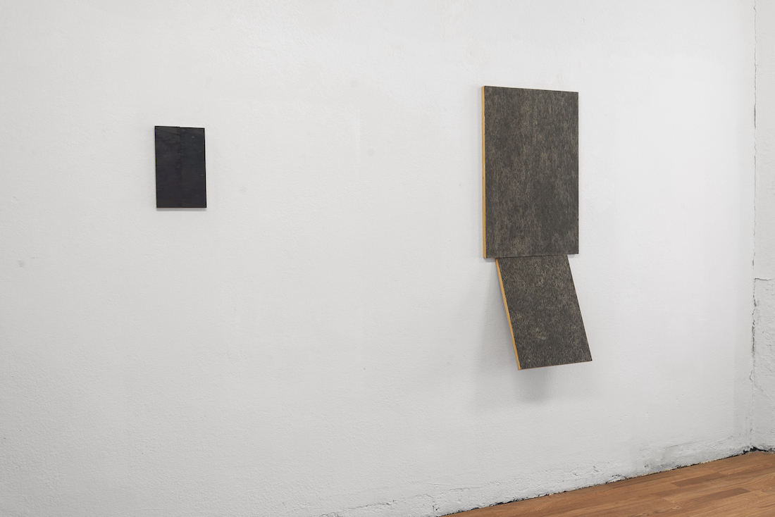 grey scale rectangular paintings on a white wall