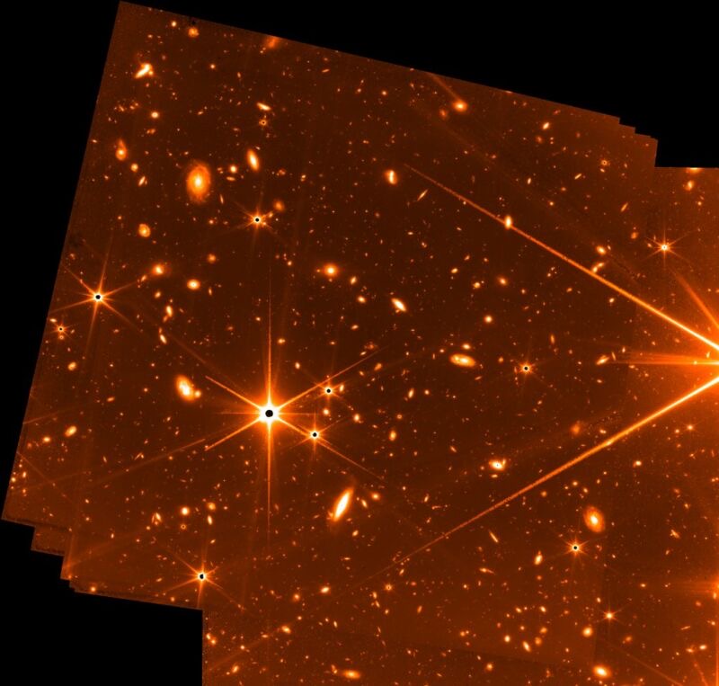 images of golden stars in black background. Looks like photos on top of one another. From the James Web Telescope