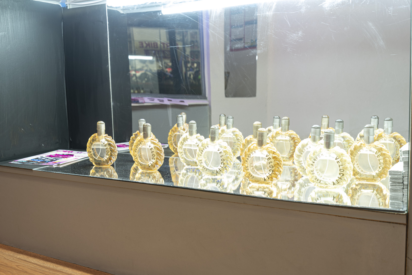 installation with glass case and perfume bottles